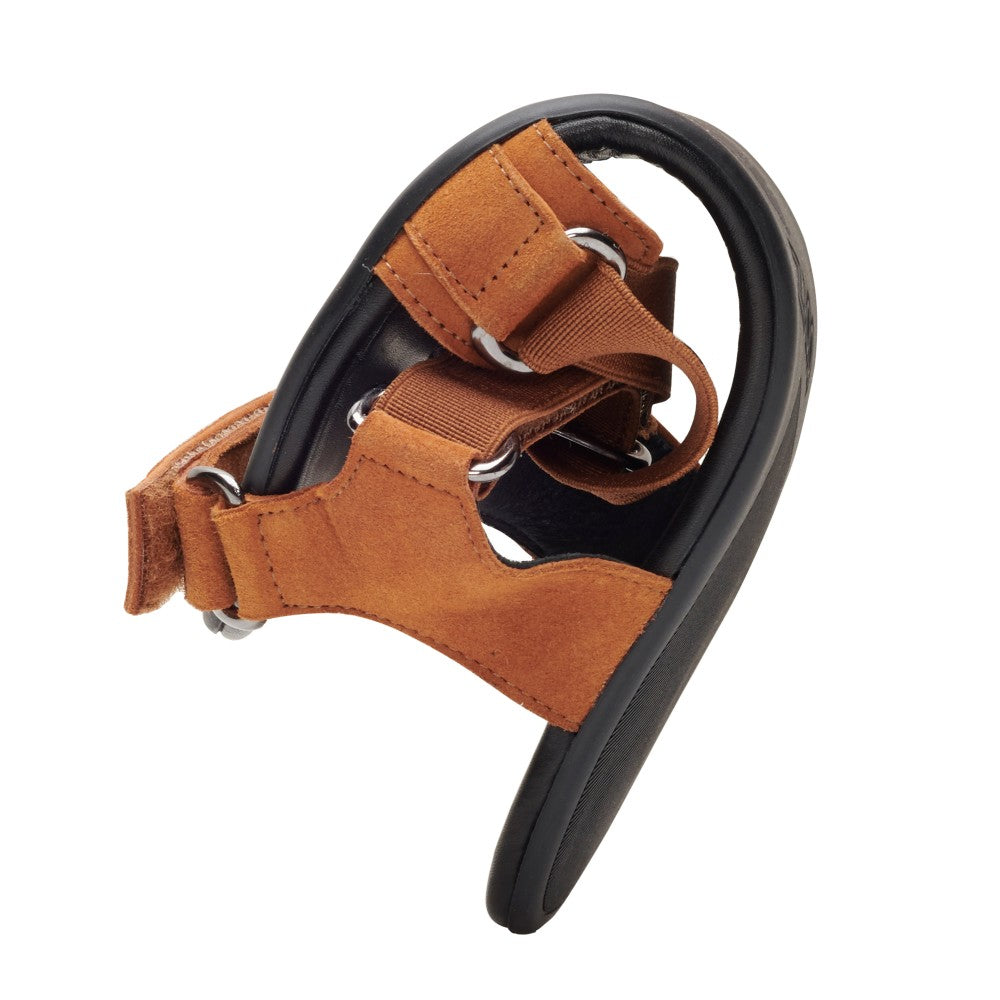 El zapato para perros MIQA Brown de ZAQQ está hecho de cuero de ante de alta calidad y cuenta con anillos de metal y un sistema de correas de velcro, permitiendo que se doble en el medio y mostrando su flexibilidad. También cuenta con una suela negra para mayor agarre y comodidad.